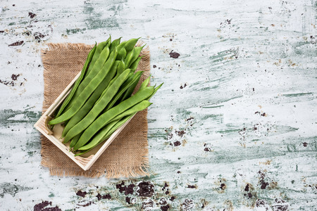 Fresh green beans on a white background with mint on white backgroundの写真素材