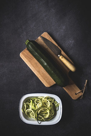 Fresh zucchini on a black background on old tableの写真素材