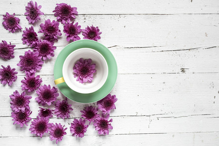 Cup of tea with Floral background and green leaves on white background. Flat lay, top viewの写真素材