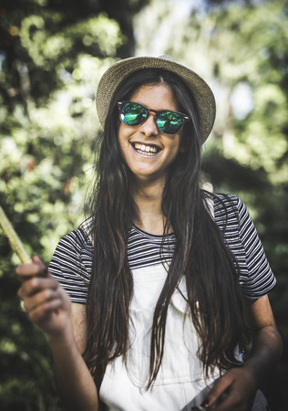 Portrait of beautiful brunette girl in a parkの写真素材