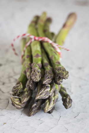 Fresh green asparagus on white wooden table.Detoxの写真素材
