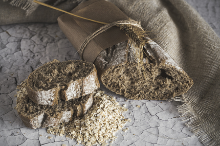 Loaves of integral bread on wooden tableの写真素材