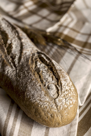 Loaves of integral bread on wooden tableの写真素材