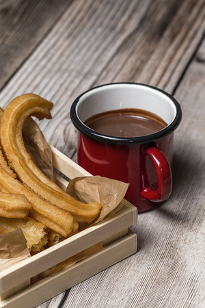 Typical Spanish churros with hot chocolate sauceの写真素材