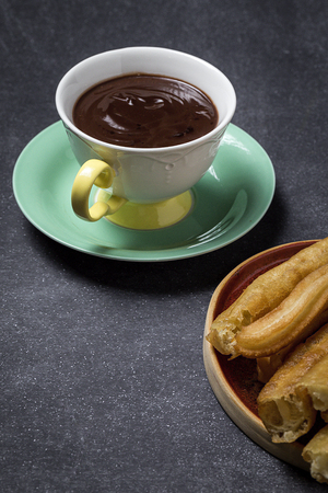 Typical Spanish churros with hot chocolate sauceの写真素材