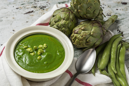 Green vegetable cream soup on wooden board. Detoxの写真素材