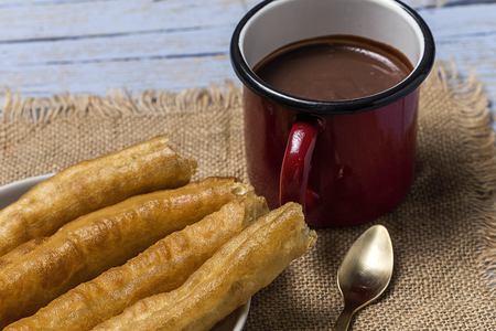 Typical Spanish churros with hot chocolate sauceの写真素材
