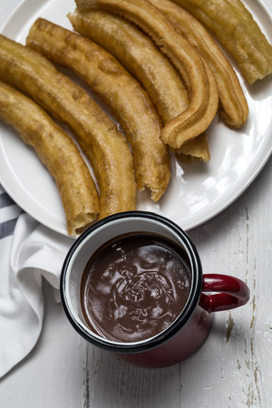 Typical Spanish churros with hot chocolate sauceの写真素材