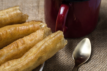 Typical Spanish churros with hot chocolate sauceの写真素材