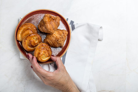 freshly baked buns with almonds.Croissants.On marble table
