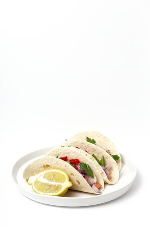 Homemade Mexican Tacos with fresh vegetables and chicken on white background. Healthy food .Burritos. Isolatedの写真素材