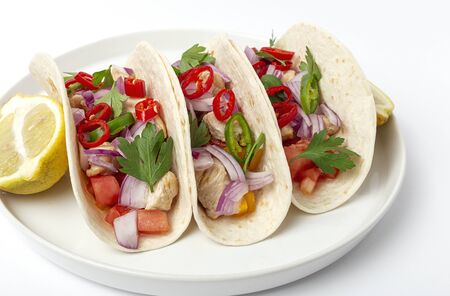 Homemade Mexican Tacos with fresh vegetables and chicken on white background. Healthy food .Burritos. Isolatedの写真素材