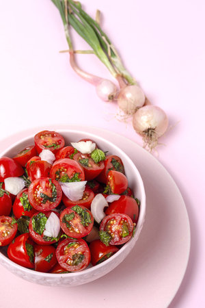 Homemade cherry tomato salad with fresh onions, mint, olive oil and salt. Vegan food. Healthy food conceptの写真素材