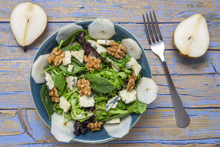 Homemade healthy lettuce assortment salad with blue cheese, walnuts and pear. Vegan food concept.Heathy foodの写真素材