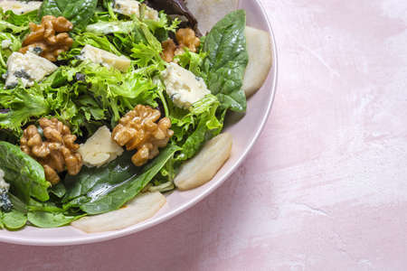 Homemade healthy lettuce assortment salad with blue cheese, walnuts and pear. Vegan food concept.Heathy foodの写真素材