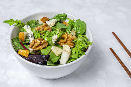 Homemade healthy lettuce assortment salad with blue cheese, walnuts and pear. Vegan food concept.Heathy foodの写真素材