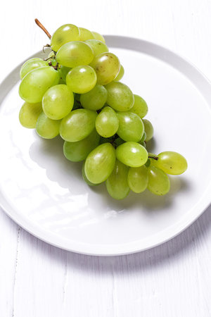 Fresh seasonal grapes in plate ready to eat On white background. Healthy food. Vegan food concept