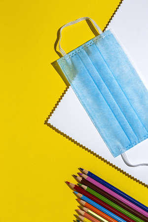 Covid-15. New normality. Material for Back to School, notebooks, colored pencils from above. Flat lay. Top viewの写真素材