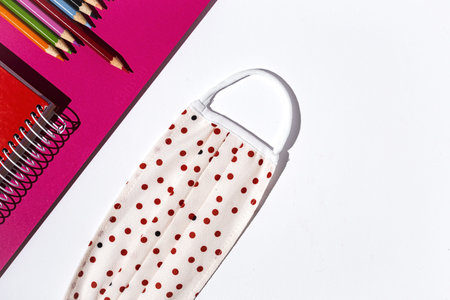 Covid-15. New normality. Material for Back to School, notebooks, colored pencils from above. Flat...