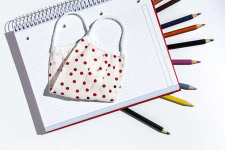 Covid-15. New normality. Material for Back to School, notebooks, colored pencils from above. Flat lay. Top viewの写真素材