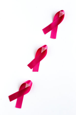 Pink ribbon on a colored background from above. Cancer disease. Flat layの写真素材
