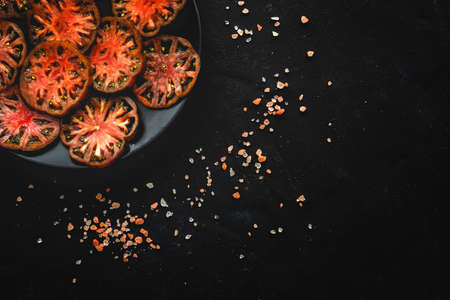 Fresh tomato carpaccio with olive oil and aromatic herbs from above. Flat lay. Vegan foodの写真素材