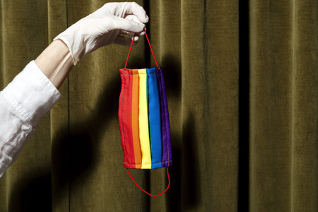 Unrecognizable woman's hands showing homemade fashion and design LGBT masks for covid-19 protection....