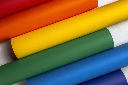 LGBT background with rainbow colored cardboard from above. Flat lay.