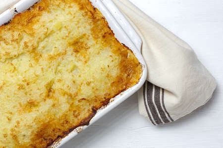 Traditional homemade shepherd pie on white background from above. Cottage foot. English food conceptの写真素材