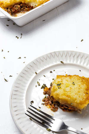 Traditional homemade shepherd pie on white background from above. Cottage foot. English food conceptの写真素材
