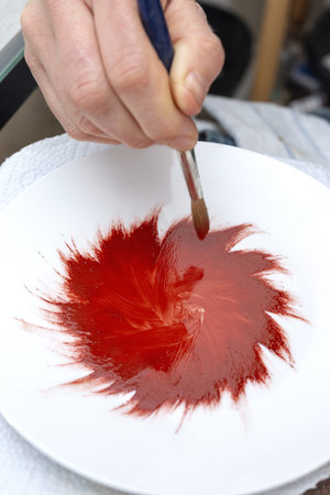 Unrecognizable woman hands working painting ceramic dishes. Craftsmanship conceptの写真素材