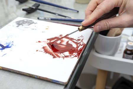 Unrecognizable woman hands working painting ceramic dishes. Craftsmanship conceptの写真素材