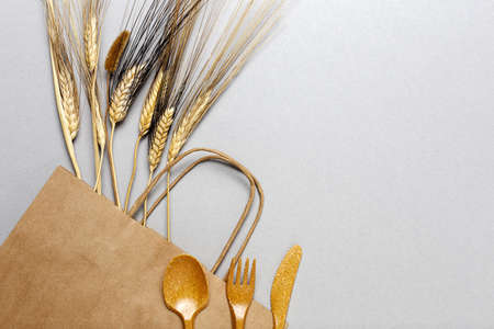 Plastic disposable tableware, forks, spoons, glasses on gray background. Caring for the environment. The problem is recycling. Reuse. Place for text.の写真素材