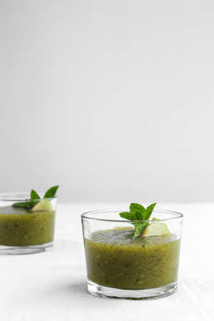 Homemade vegetable green smoothie with apple, cucumber, mint and lime. Detox concept. Vegan drinkの写真素材