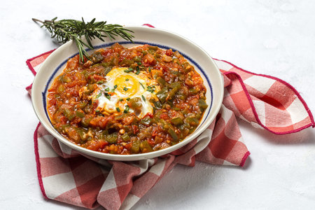 Vegetable dish pisto manchego made of tomatoes, zucchini, peppers, onions with fried egg. Typical Spanish foodの写真素材