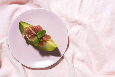 Sliced fresh melon with ham with sunlight on colorful backgrounds. Spanish food conceptの写真素材