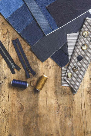 Handicraft, clothing repair. Ripped blue jeans sewing accessories from above. Flat layの写真素材