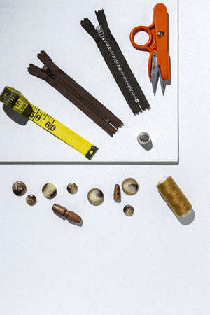 Handicraft, clothing repair. Ripped blue jeans sewing accessories with colorful background from above. Flat layの写真素材