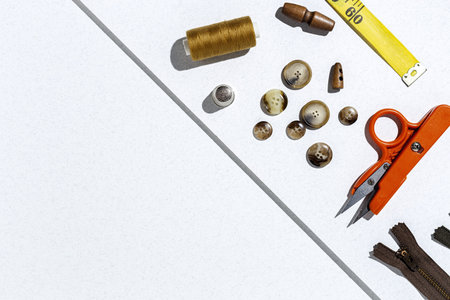 Handicraft, clothing repair. Ripped blue jeans sewing accessories with colorful background from above. Flat layの写真素材