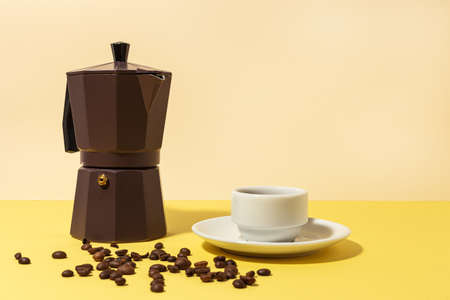 Traditional Italian Coffee Maker with high contrast light on colored backgroundsの写真素材