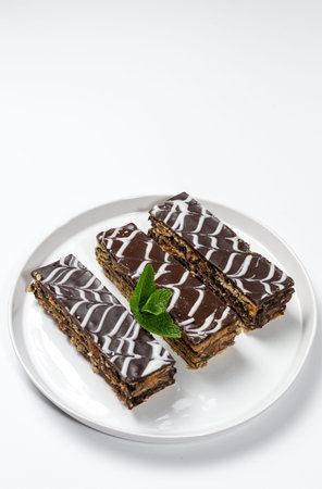 Traditional chocolate Millefoglie or French mille-feuille on white background with copy space