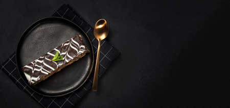 Traditional chocolate Millefoglie or French mille-feuille on dark background with copy spaceの写真素材