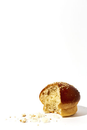 Assorted round homemade brioche buns with seeds on a white background with high contrast light. Isolatedの写真素材