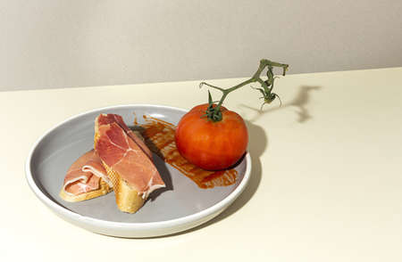 Traditional Spanish Iberian Serrano Ham with tomato. Parma ham Italian antipastoの写真素材