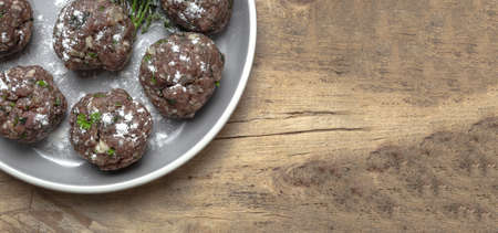 Traditional homemade recipe for raw beef and lamb meatballs with flour, egg, spices and aromatic herbs. Typical Spanish foodの写真素材