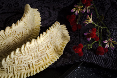 Homemade sweets from gazelle horns for Ramadan. Close-up detail shot of fresh baked Kaab El Ghazal,...