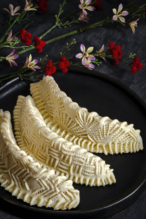 Homemade sweets from gazelle horns for Ramadan. Close-up detail shot of fresh baked Kaab El Ghazal,...