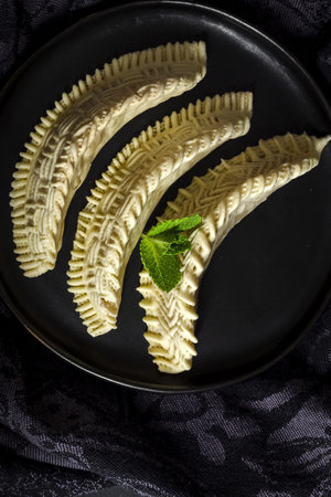 Homemade sweets from gazelle horns for Ramadan. Close-up detail shot of fresh baked Kaab El Ghazal, a moroccan sweet also known as gazelle horns, Halal foodの写真素材
