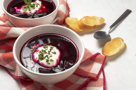 Traditional Ukrainian and Russian national red borscht soup in bowl with sour cream and herbs. Healthy food conceptの写真素材