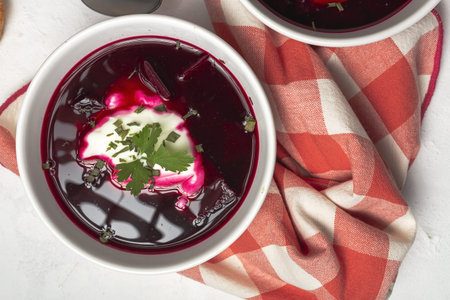 Traditional Ukrainian and Russian national red borscht soup in bowl with sour cream and herbs. Healthy food conceptの写真素材